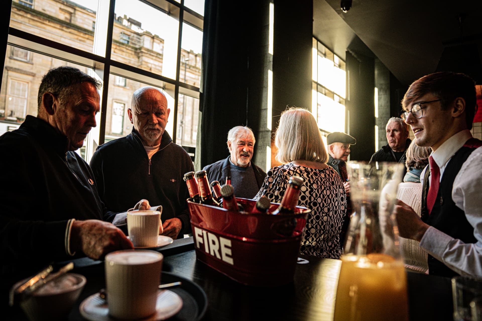 Guests socialising over drinks in a lively city hotel bar